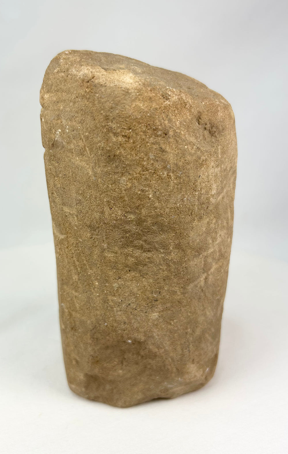 Pre-Columbian stone ritual figure with almond-shaped eyes and schematic facial features