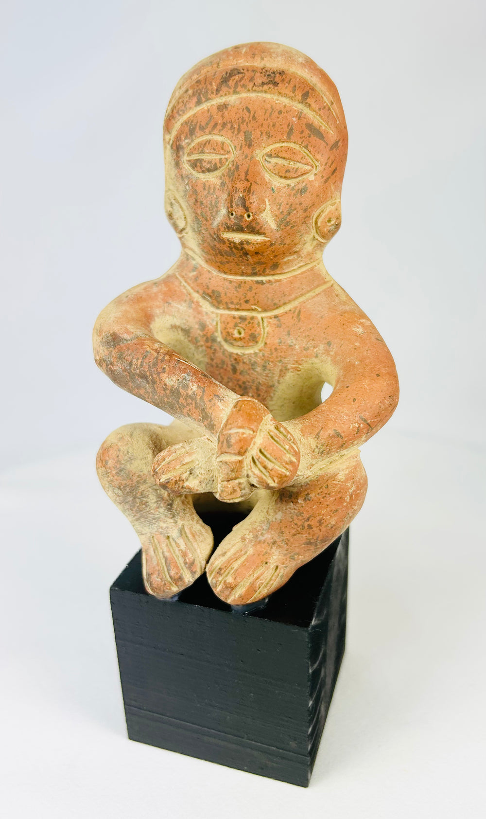 Hand-molded West Mexican terracotta figure with red slip, stylized anthropomorphic features, burnished surface