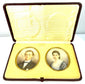 Front view of two antique colour portrait miniatures arranged side by side within an elegant burgundy leather-covered presentation case.