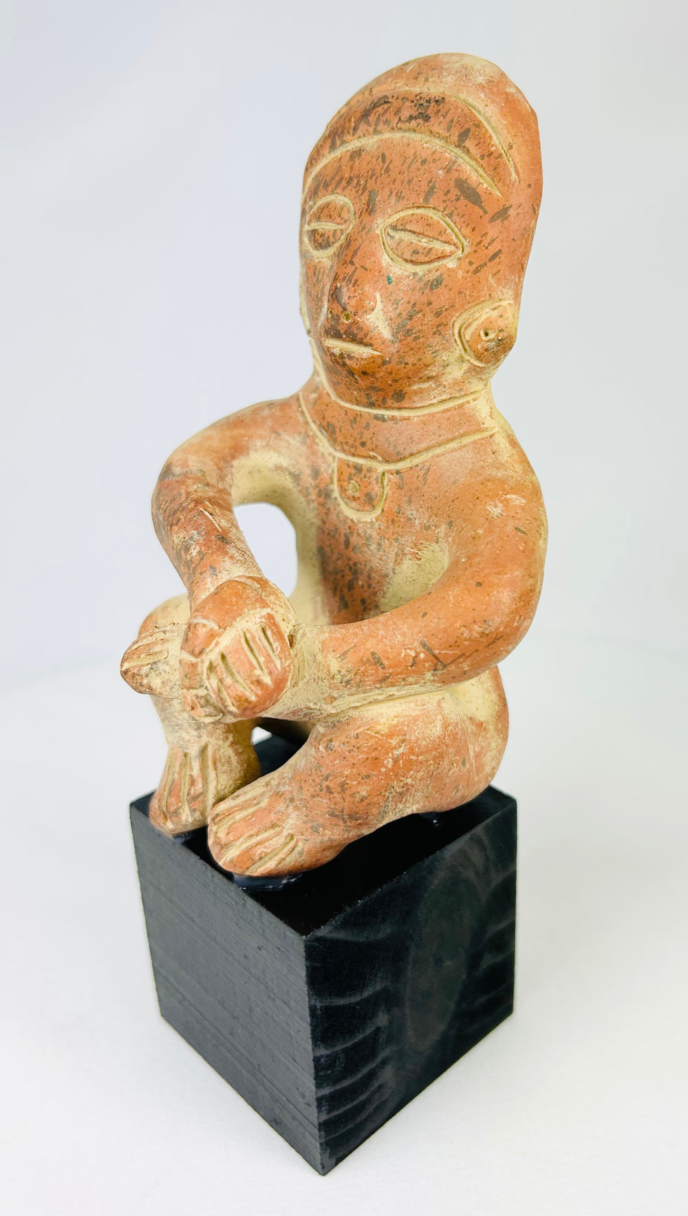 Nayarit/Jalisco Pre-Columbian terracotta funerary figure, circa 300 BCE–300 CE, seated pose, black display stand