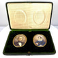 Open antique double portrait case featuring two oval colour miniatures, gilt-coloured metal surrounds, and cream patterned interior lining.