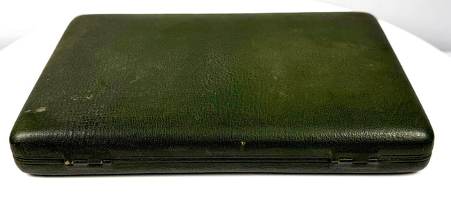 Side-angle view of the closed antique green leather portrait case showing its slim profile, rounded edges, and aged surface finish.