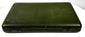 Side-angle view of the closed antique green leather portrait case showing its slim profile, rounded edges, and aged surface finish.