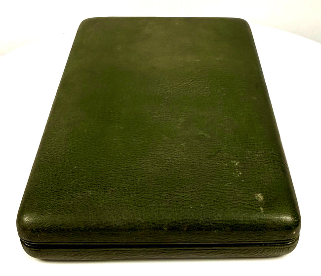 Antique green leather-covered portrait case shown closed, displaying its protective exterior, rounded corners, and age-related surface wear.