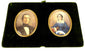 Removable double portrait panel featuring colour miniatures of a gentleman and woman in gilt-coloured oval frames against dark green velvet.