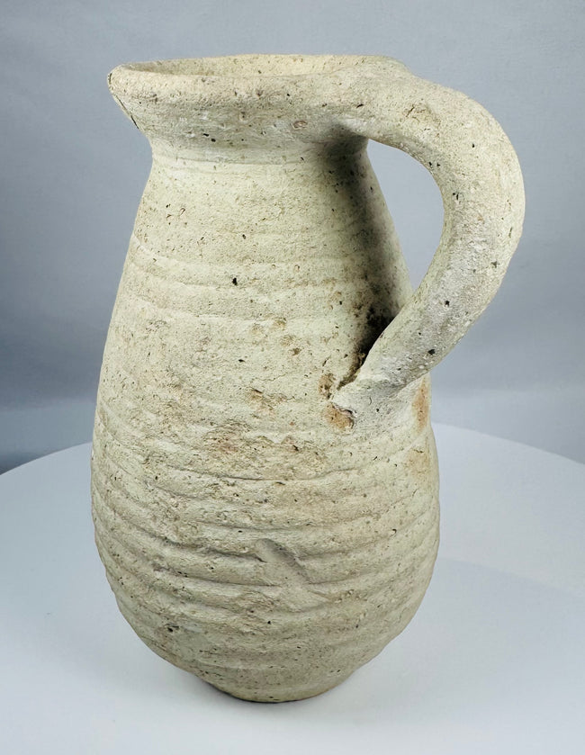 Ancient Tunisian terracotta vessel dating to the Roman Imperial period with a sturdy loop handle.