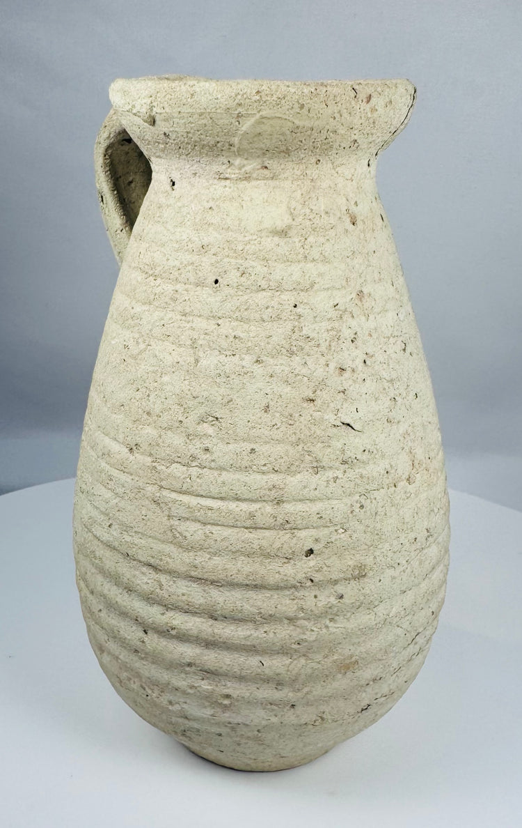 Ancient Roman terracotta pitcher from Africa Proconsularis with ribbed body and flared rim.