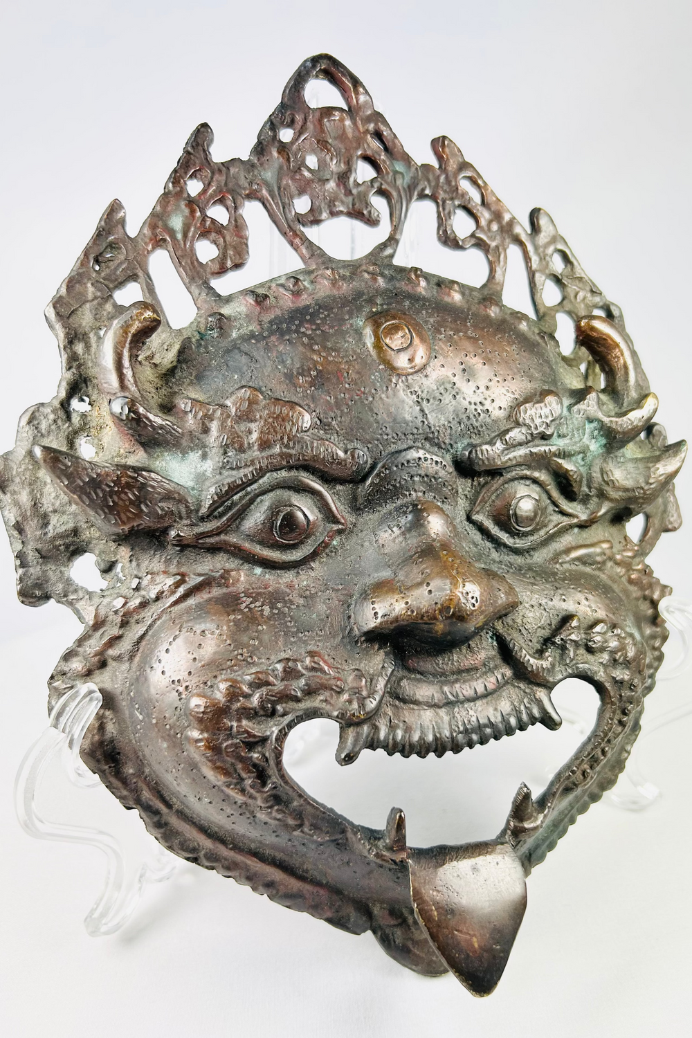 Square-form Himalayan ritual mask showing fierce guardian expression and deep patinated surface