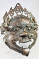 Square-form Himalayan ritual mask showing fierce guardian expression and deep patinated surface