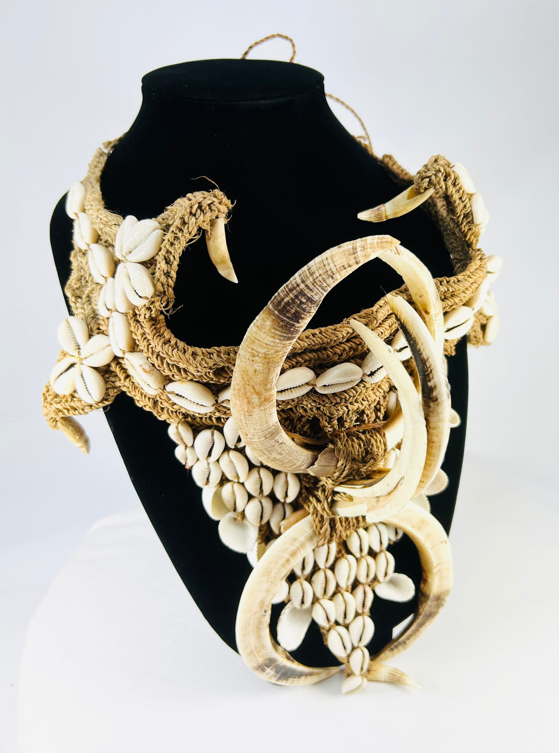 Early 20th century Papua New Guinea ceremonial apron, featuring boar tusks, cowrie shells, and natural fiber bindings, used in tribal initiations and dances, ethnographic Melanesian artifact