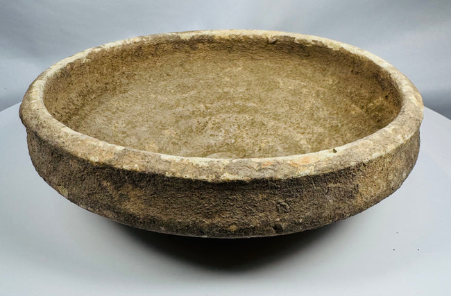 Side profile of a Roman North African pottery bowl illustrating its thickened rim and gently sloping walls.