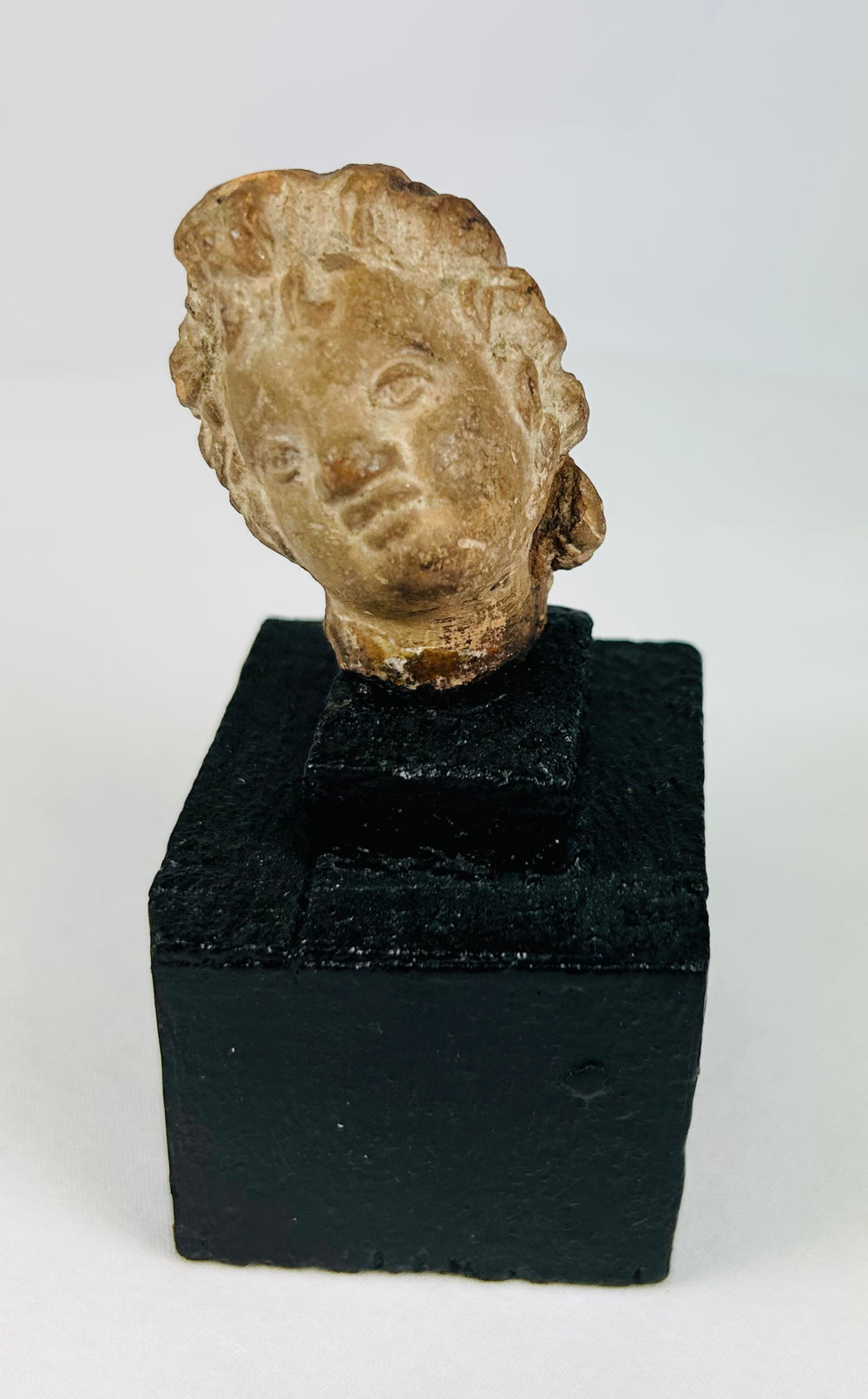 Archaic terracotta or stone head fragment from the ancient Mediterranean, display-mounted collectible