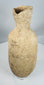 Side view of an ancient Roman Provincial terracotta pouring vessel highlighting its globular form and flared rim.
