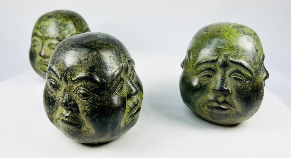 Himalayan-style cast metal Buddhist heads with weighted sand-filled interiors