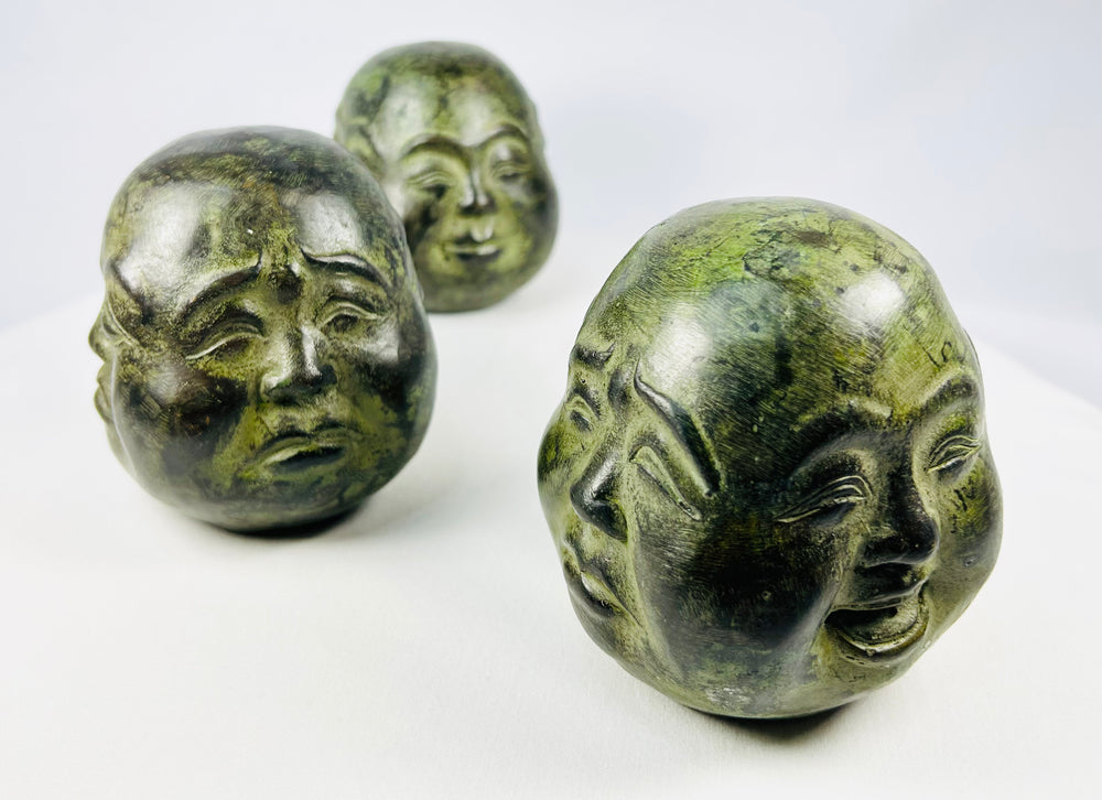 Buddhist devotional head figures housed in decorative brocade presentation box