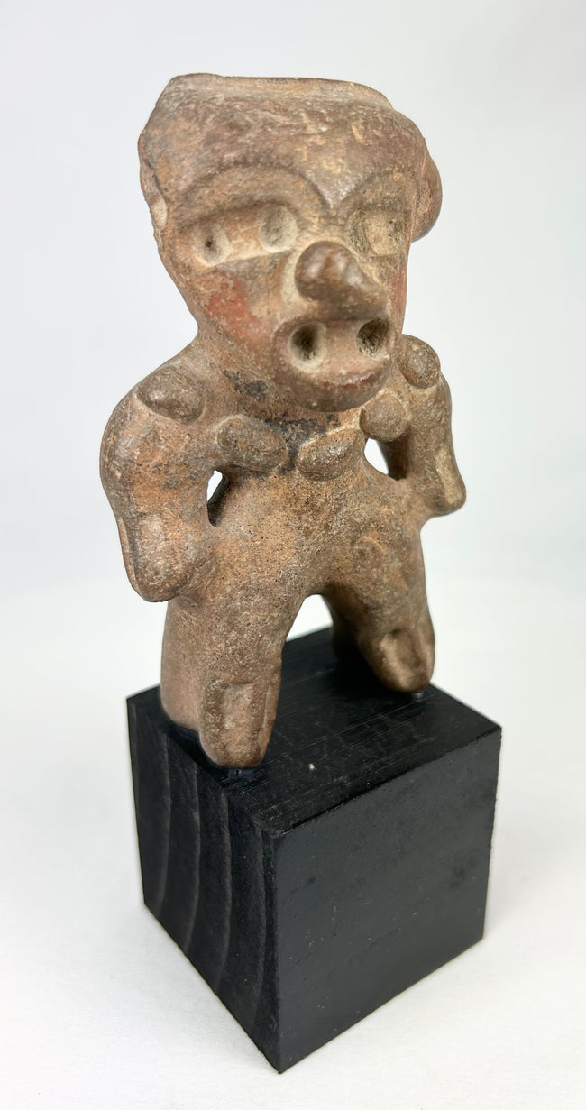 Ancient West Mexico anthropomorphic terracotta figure with stylized head and pierced ears