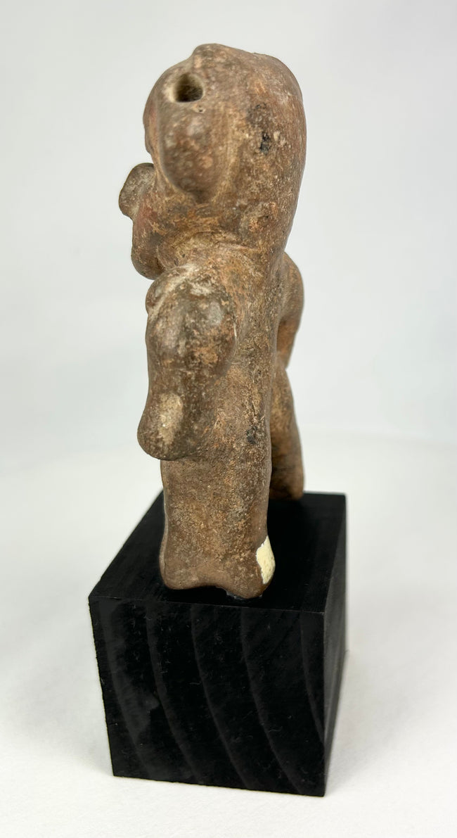 West Mexican terracotta tomb figure featuring a large stylized head and pierced ears