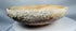 Authentic Byzantine pottery bowl displaying marine encrustations and archaeological mineral deposits.