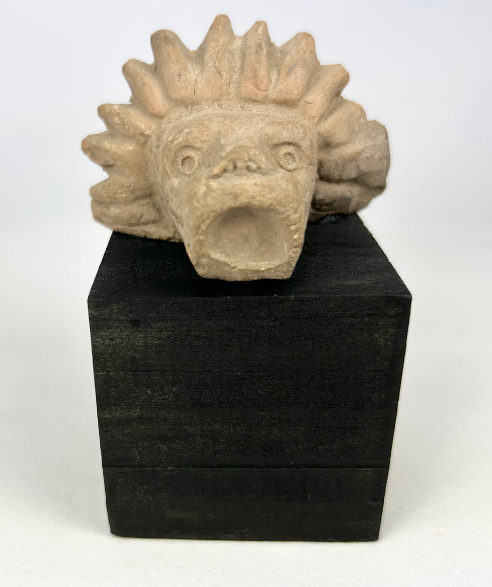 Ancient stone animal head sculpture fragment with jaguar-like features