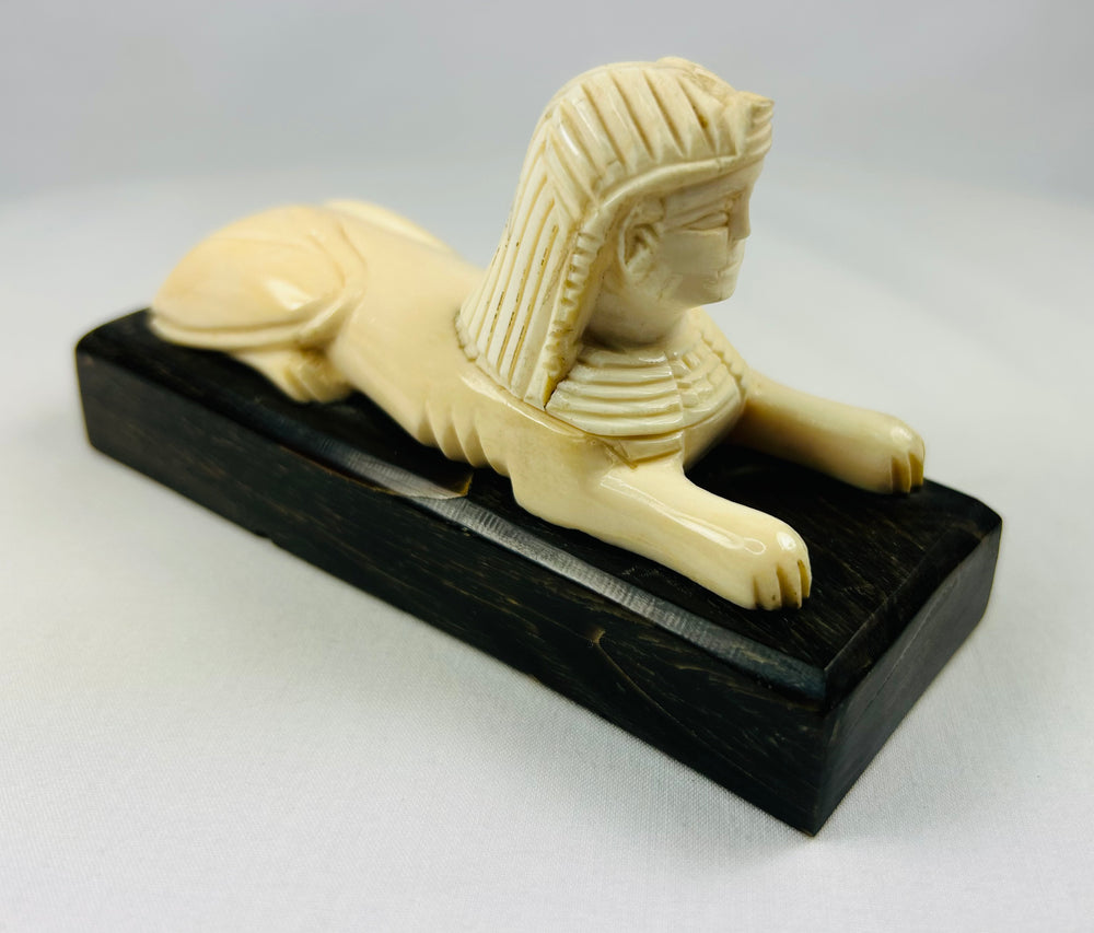 Vintage Egypt-inspired sphinx figurine reflecting early 20th century archaeological revival