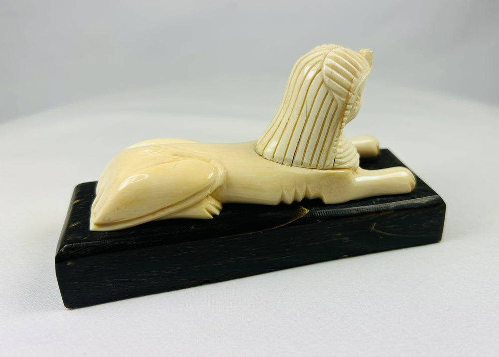 Early 1900s Egyptian revival sphinx sculpture mounted on original black wood base