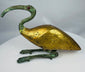 Mid-20th century Egyptian Revival ibis sculpture featuring a gold-colored body and green patinated metal elements.