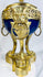 Decorative French ormolu and porcelain vase with openwork gallery, pinecone finial, and Classical design elements.