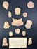 Collection of ancient ceramic figurines on a dark background with an informational card.