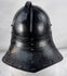 Collectible seventeenth-century forged iron armour helmet from Northern Europe with aged black painted surface.