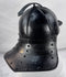 Rare Northern European forged iron combat helmet featuring rolled borders, ring finial, and articulated neck defense.