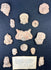Shadowbox display of ancient Mesoamerican terracotta artifacts including spindle whorls