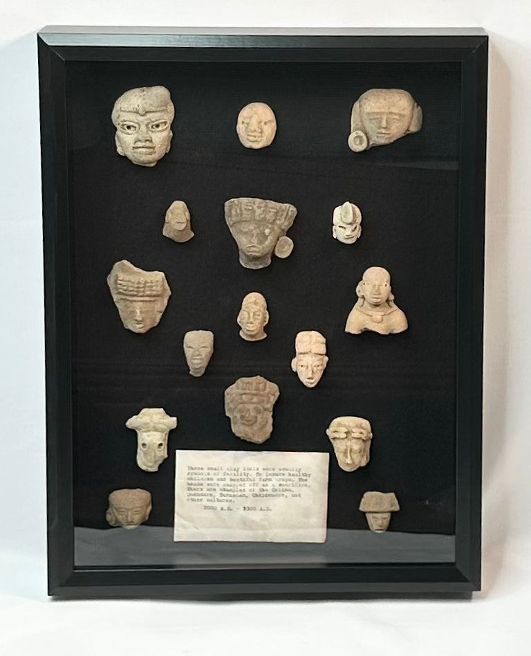 Ancient Mesoamerican terracotta fragment collection, 16 ritual heads and maskettes, 200 BCE–900 CE, shadowbox mounted