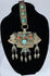 Traditional Himalayan gau amulet case featuring repoussé metalwork, turquoise inlay, and suspended pendant drops.