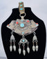 Historic Tibetan Buddhist portable shrine decorated with repoussé floral motifs and turquoise cabochons.