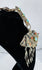 Antique Tibetan Buddhist gau amulet case displaying repoussé floral decoration and protective turquoise cabochons.