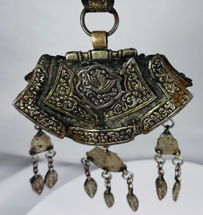Himalayan silvered copper gau pendant with coral accents, articulated drops, and original textile suspension.