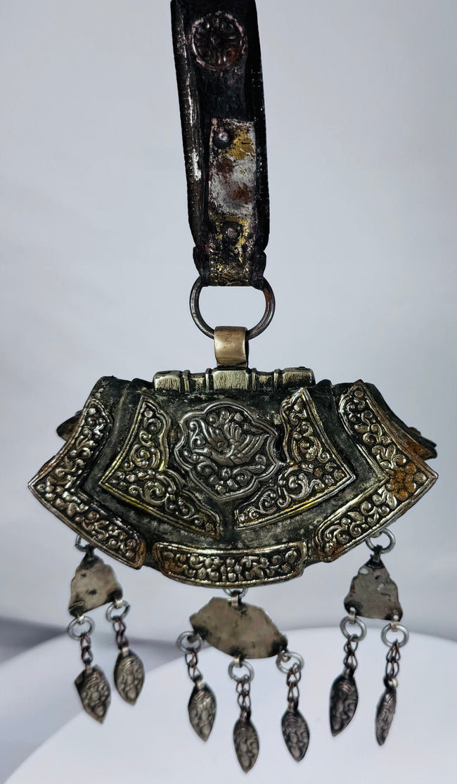 Authentic Himalayan ceremonial ornament featuring turquoise, coral, silvered copper alloy, and ornate repoussé craftsmanship.