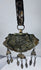 Authentic Himalayan ceremonial ornament featuring turquoise, coral, silvered copper alloy, and ornate repoussé craftsmanship.