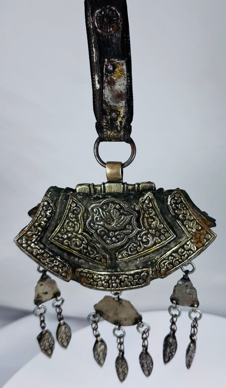 Authentic Himalayan ceremonial ornament featuring turquoise, coral, silvered copper alloy, and ornate repoussé craftsmanship.