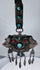 Late 19th century Tibetan ceremonial chest ornament with silvered metal, turquoise, coral, and hanging pendants.