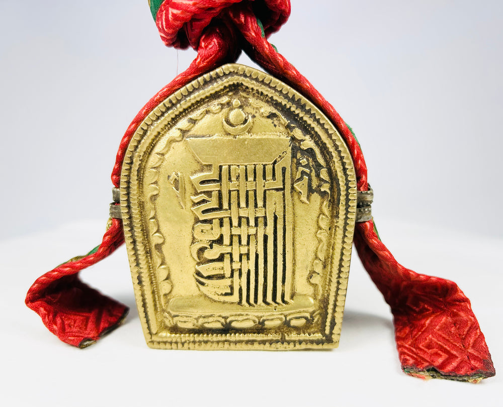 Tibetan gau amulet box shrine, brass with raised script and original woven strap and pouch