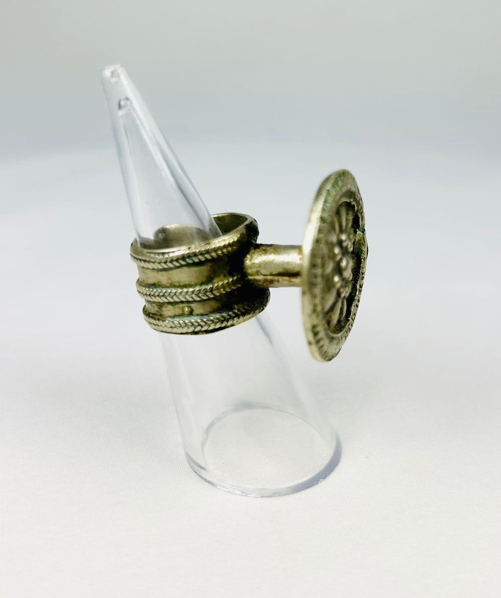 European Victorian-era silver-toned ring with central floral rosette and elegant taper.