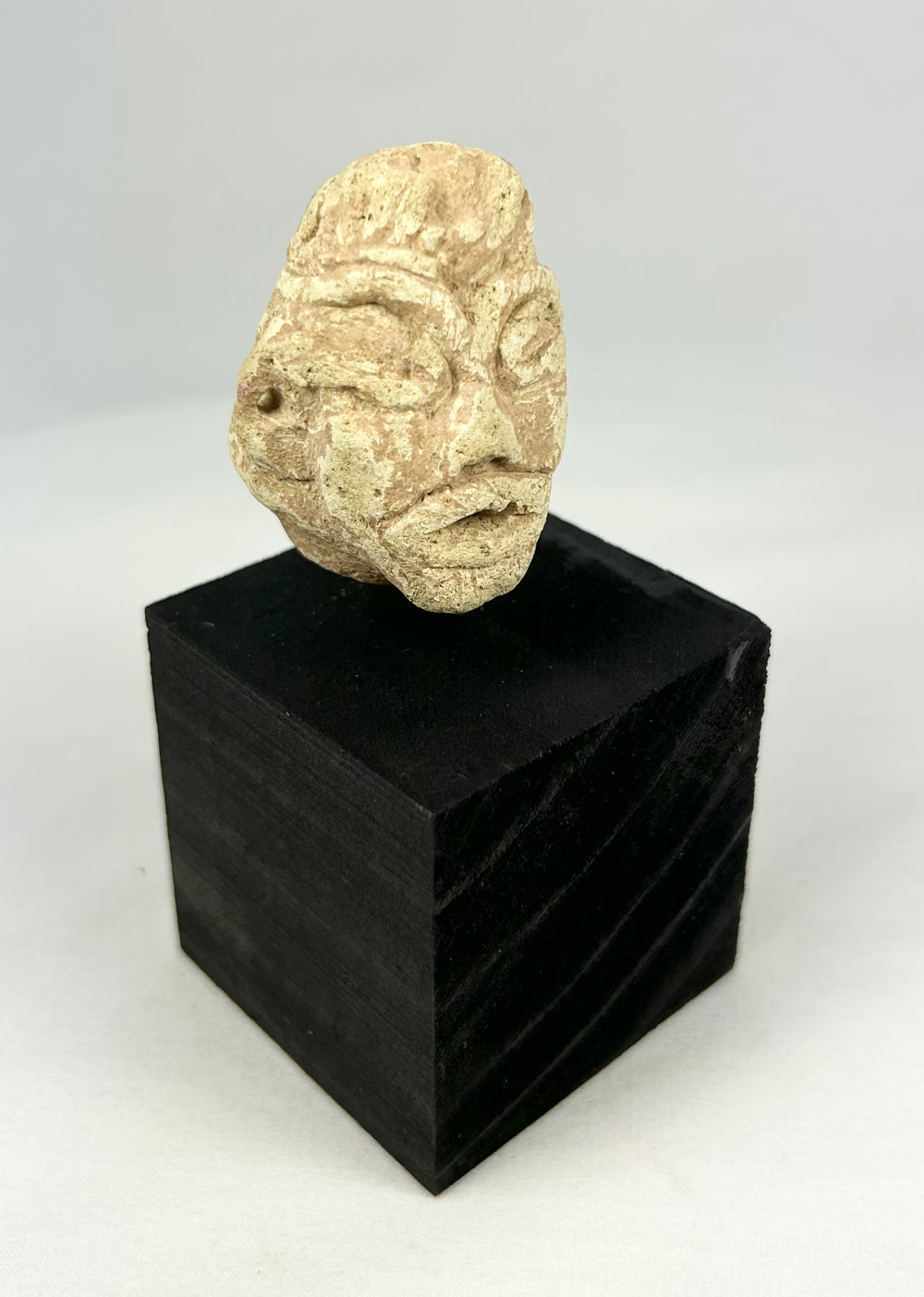 Near Eastern Mesopotamian carved stone head, early votive idol fragment with broad nose and stylized eyes