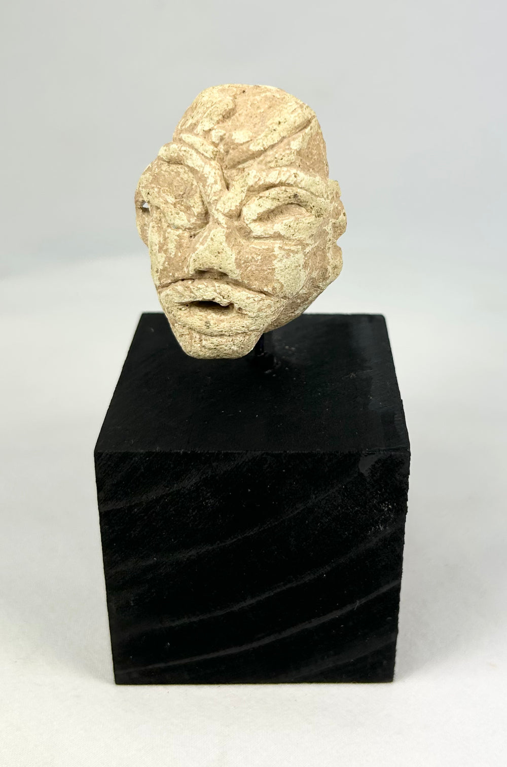 Ancient Near Eastern carved stone idol head, Mesopotamian ritual fragment with stylized facial features