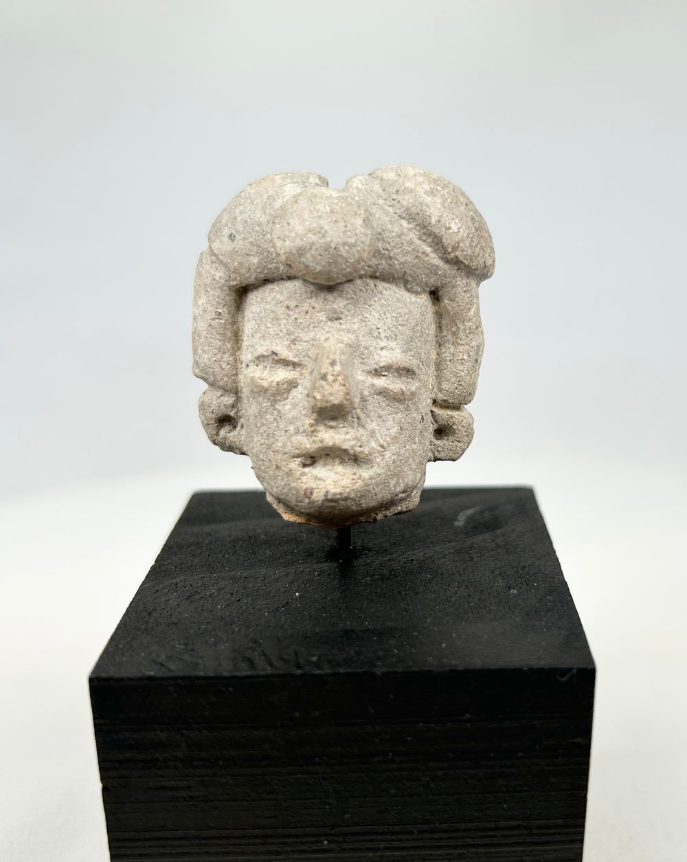 Mounted West Mexican terracotta head fragment from Nayarit/Jalisco, photographed on white background