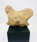 Ancient terracotta head from shaft-tomb culture, mounted for display