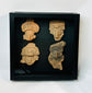 Ancient terracotta face fragments with expressive features, Pre-Columbian display