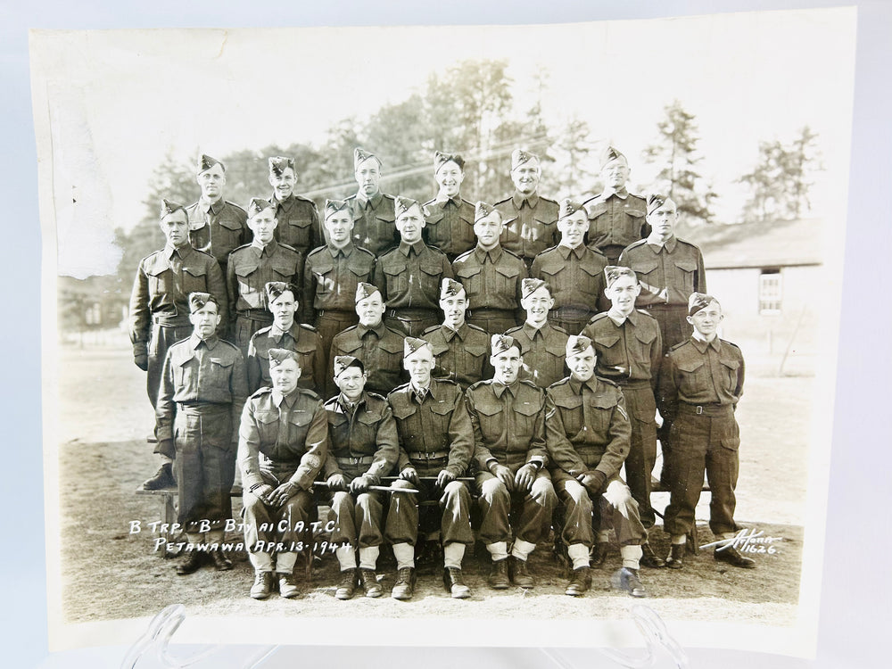 Vintage World War I soldier memorabilia: compass, spent shell, and sepia photograph of troops