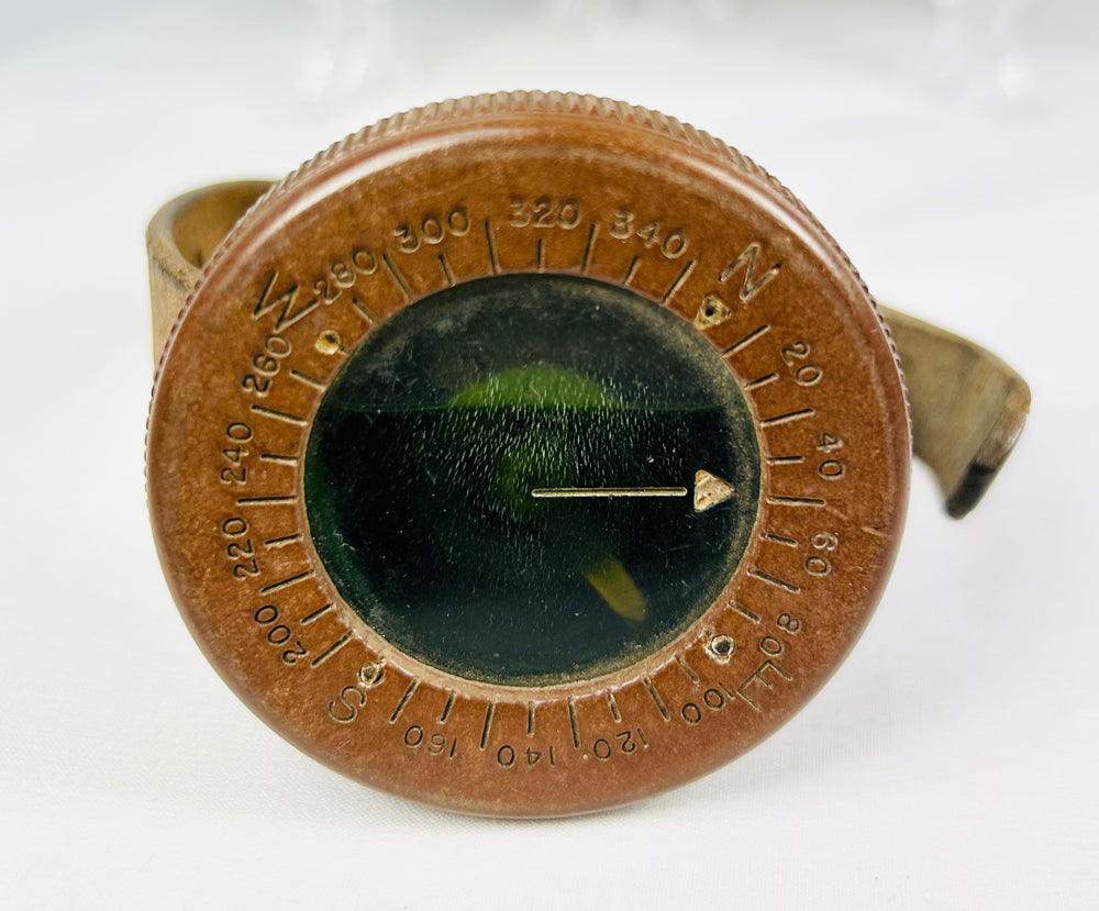 World War I soldier’s compass with shell casing and troop photograph, vintage military display