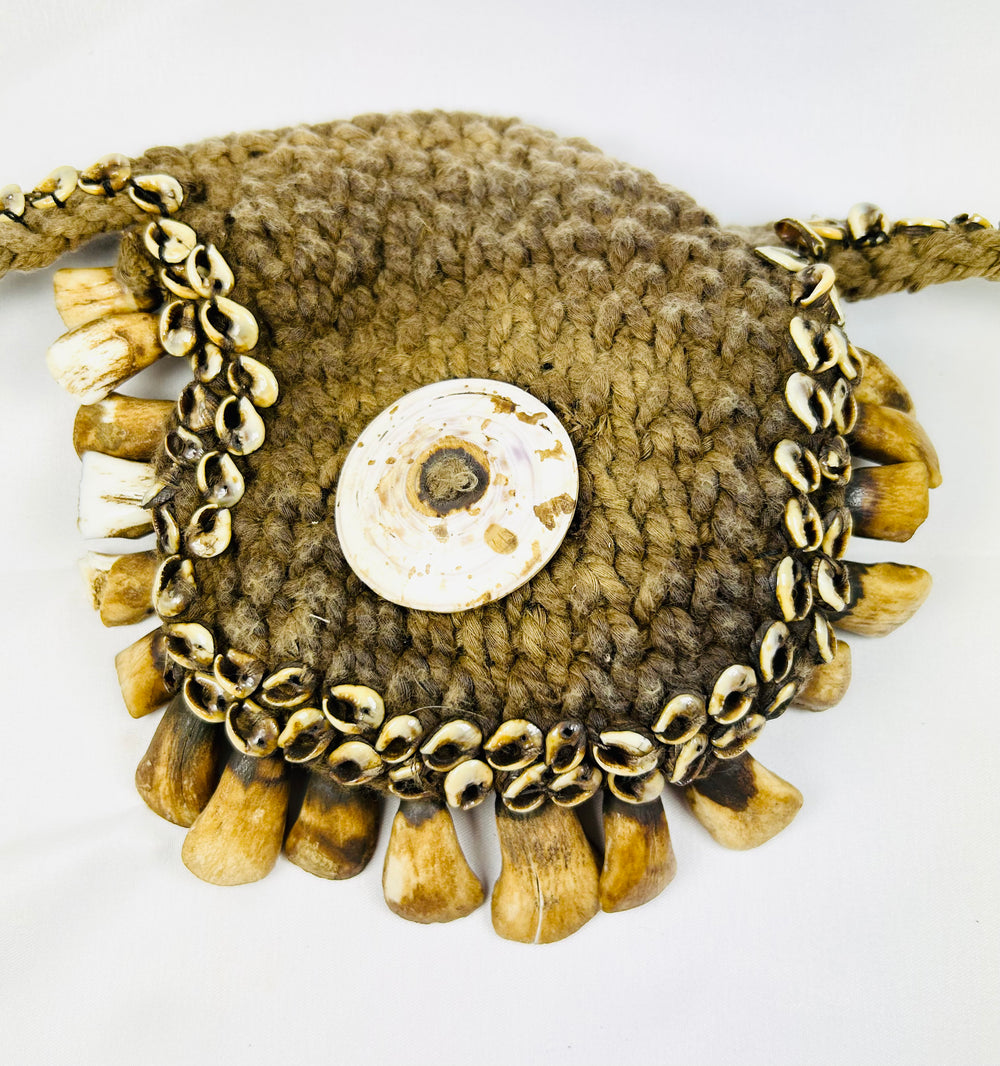Tribal ceremonial adornment from Papua New Guinea with pierced animal teeth fringe
